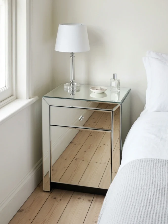 Bedroom with reflective furniture.